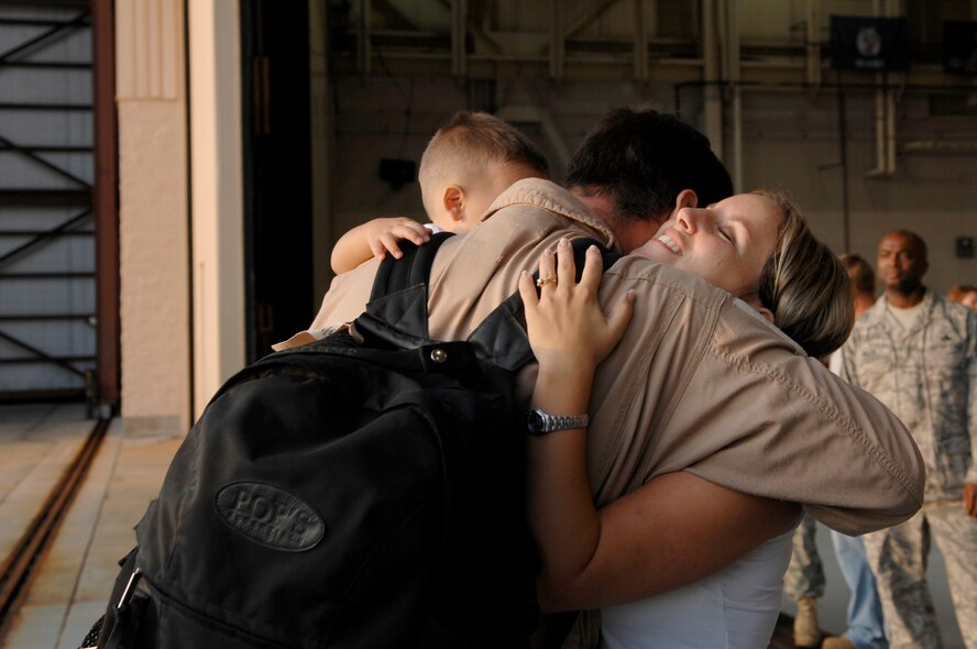 Tech. Sgt. Jasun Martinez, 4th Special Operations Squadron, hugs his family after a deployment Sept. 6; Hurlburt Field, Fla. Operation Homecoming allows family, friends, and co-workers to reunite with their loved ones as soon as they land after a deployment. (U.S. Air Force photo/ Senior Airman Julianne Showalter)(RELEASED)