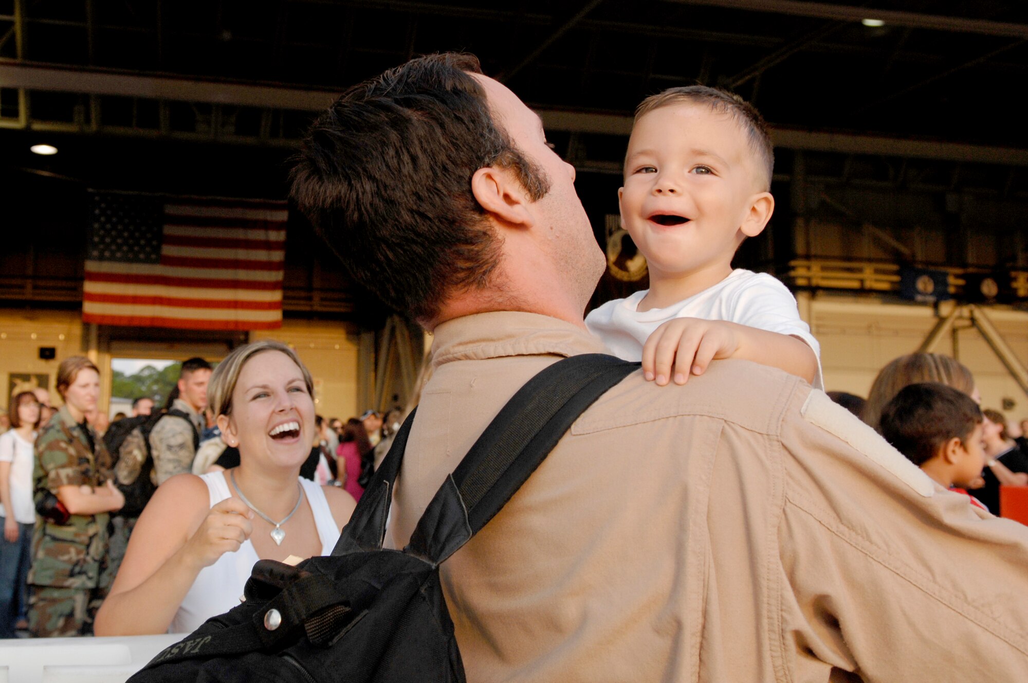 Jasun Martinez Jr.  proudly smiles in the arms of his father Tech. Sgt. Jasun Martinez, 4th Special Operations Squadron, who just returned from deployment Sept. 6; Hurlburt Field, Fla. Operation Homecoming allows family, friends, and co-workers to reunite with their loved ones as soon as they land after a deployment. (U.S. Air Force photo/ Senior Airman Julianne Showalter)(RELEASED)