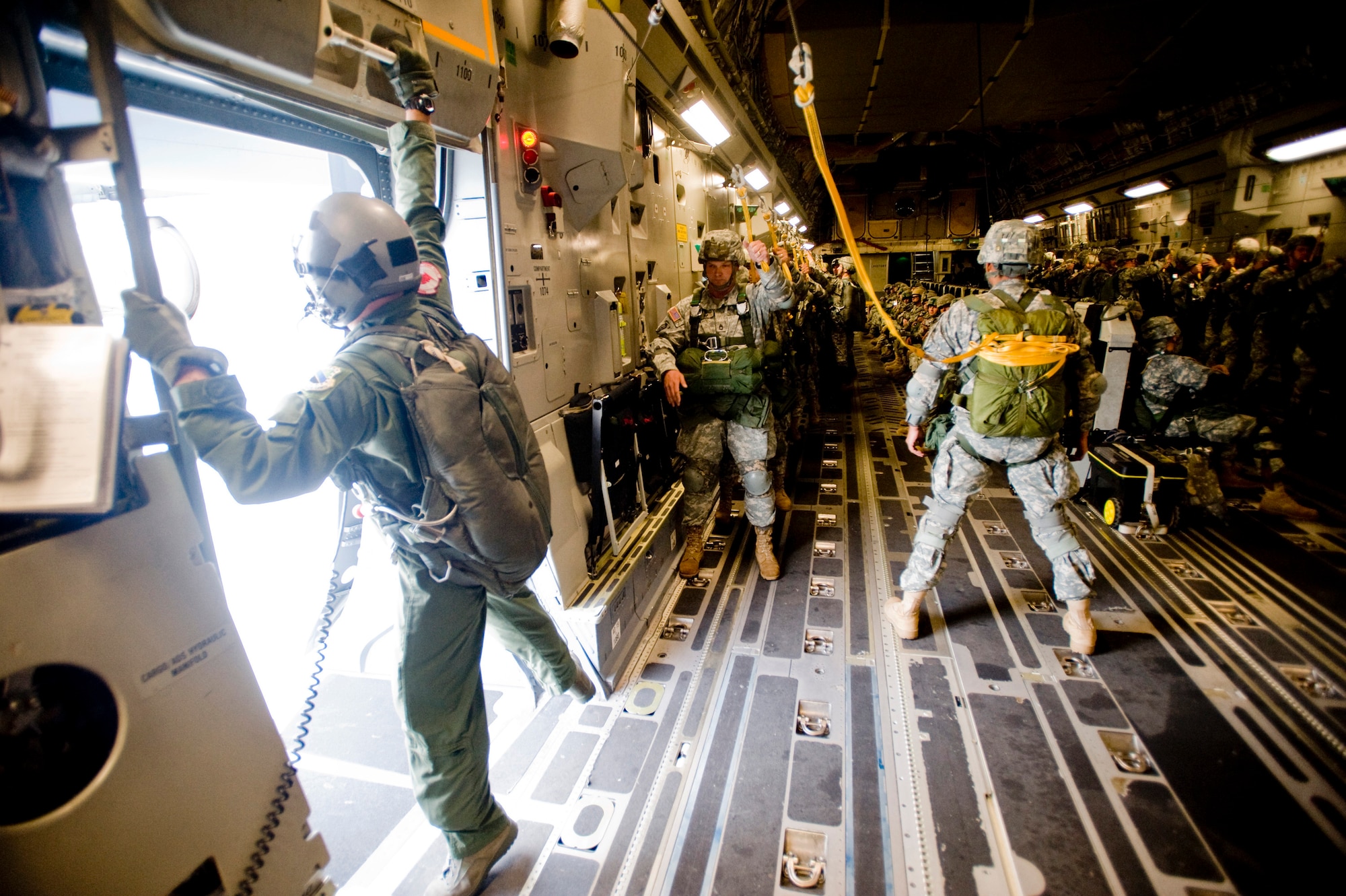 ELMENDORF AIR FORCE BASE, Alaska -- Staff Sgt. Jeremy White, a 517th Airlift Squadron loadmaster, opens the troop door for the Soldiers of the 1-40 Cavalry Sept. 5. The 1-40 Cavalry conducts independent reconnaissance and security missions in support of 4th Brigade Combat Team (Airborne), 25th Infantry Division operations at Fort Richardson. (U.S. Air Force photo/Senior Airman Jonathan Steffen)
