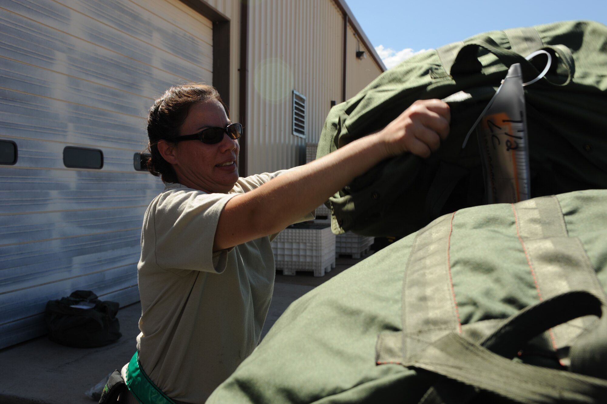 DYESS AIR FORCE BASE, Texas - Technical Sergeant Michelle Manjarrez, 7th Logistics Readiness Squadron, stacks mobility bags during the Operational Readiness Exercise at the Deployment Control Center, here, Sept. 6. To accelerate the process, mobility bags are separated into two piles, cold weather bags and chemical warfare bags. Exercises are designed to help Dyess AFB Airmen plan and prepare for real world deployments in support of war efforts. (U.S. Air Force photo/ Senior Airman Courtney Richardson)