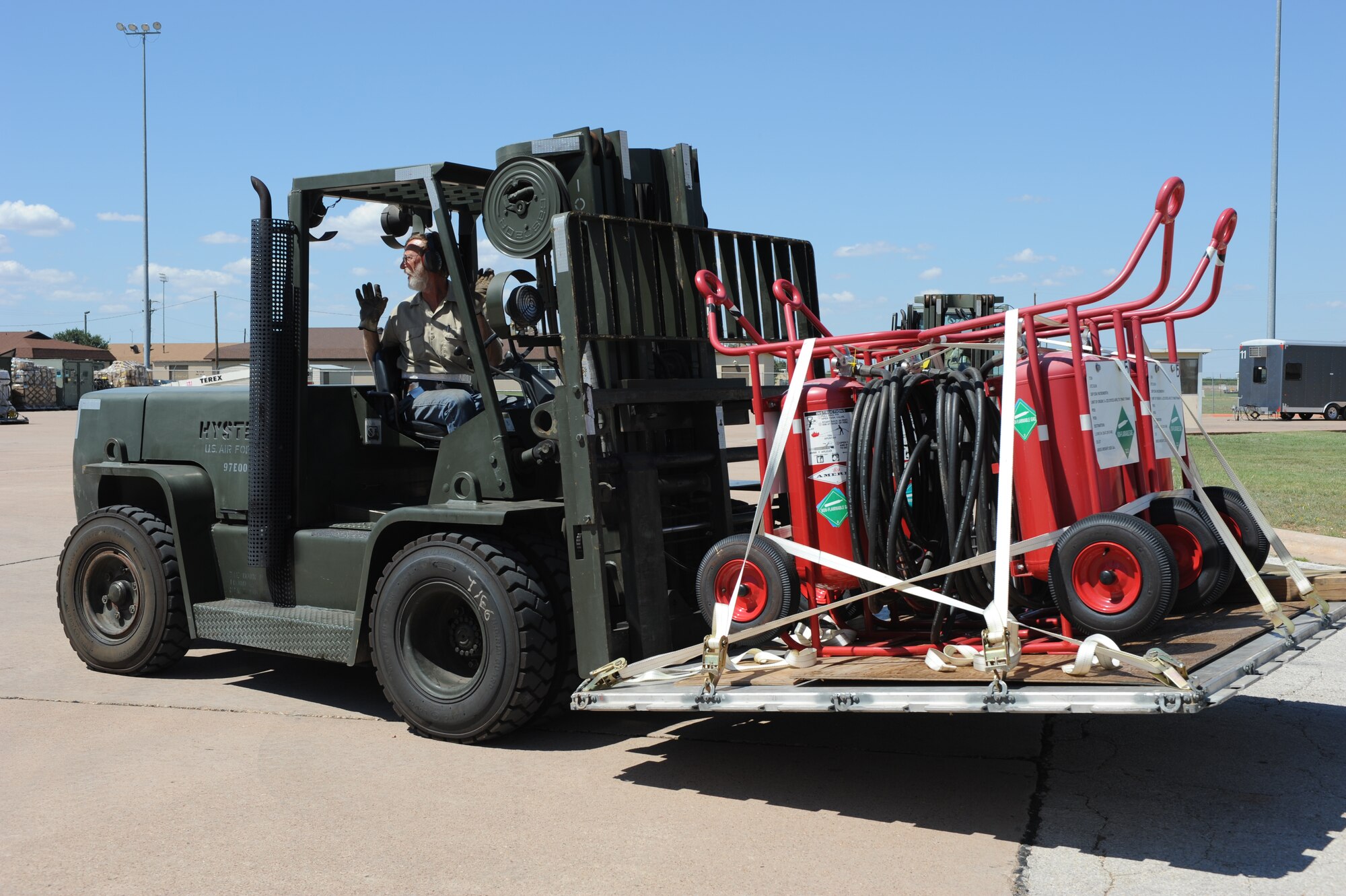 DYESS AIR FORCE BASE, Texas - Terry Kent, 7th Logistics Readiness Squadron, transports aircraft fire extinguishers to the flight line during the Operational Readiness Exercise at the Deployment Control Center, here, Sept. 6. When aircraft are parked on the flight line, fire extinguishers are mandatory in case of aircraft emergencies. Exercises are designed to help Dyess AFB Airmen plan and prepare for real world deployments in support of war efforts. (U.S. Air Force photo/ Senior Airman Courtney Richardson)