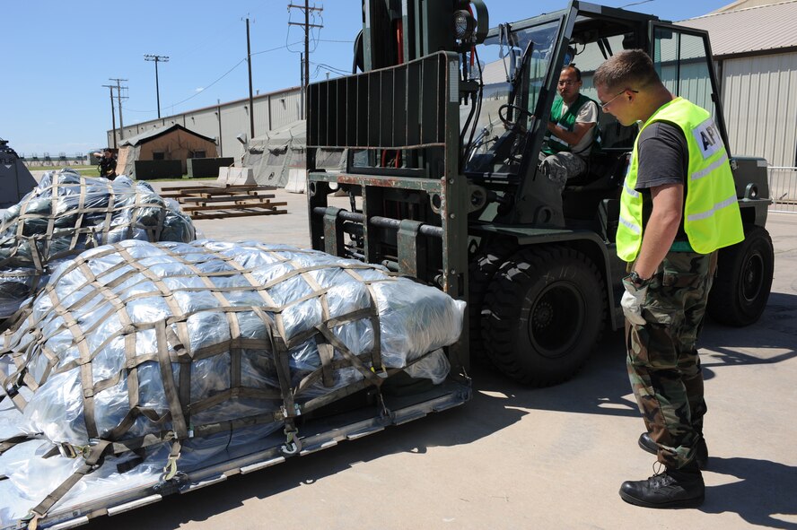 DYESS AIR FORCE BASE, Texas - Senior Airman Scotty Morgan, 7th Logistics Readiness Squadron, receives directions from Senior Airman Ryan Stuckey, 317th Aircraft Maintenance Squadron, as he prepares to transport cargo to the weight station during the Operational Readiness Exercise at the Deployment Control Center, here, Sept. 6. Cargo must be weighed to determine how much can be placed safely on an aircraft. Exercises are designed to help Dyess AFB Airmen plan and prepare for real world deployments in support of war efforts. (U.S. Air Force photo/ Senior Airman Courtney Richardson)