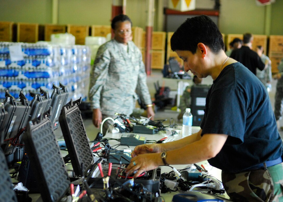 Technical Sgt. Norma Cruz of the 149th Fighter Wing, Texas Air National Guard tests Global Positioning Systems.  The GPS's will be installed onto buses that will transport Hurricane Ike evacuees to different locations throughout the state.  Units from the Texas Military Forces began mobilization efforts today at Kelly USA, San Antonio, Texas.  (Photo by: Staff Sgt. Andre' Bullard) (Released)