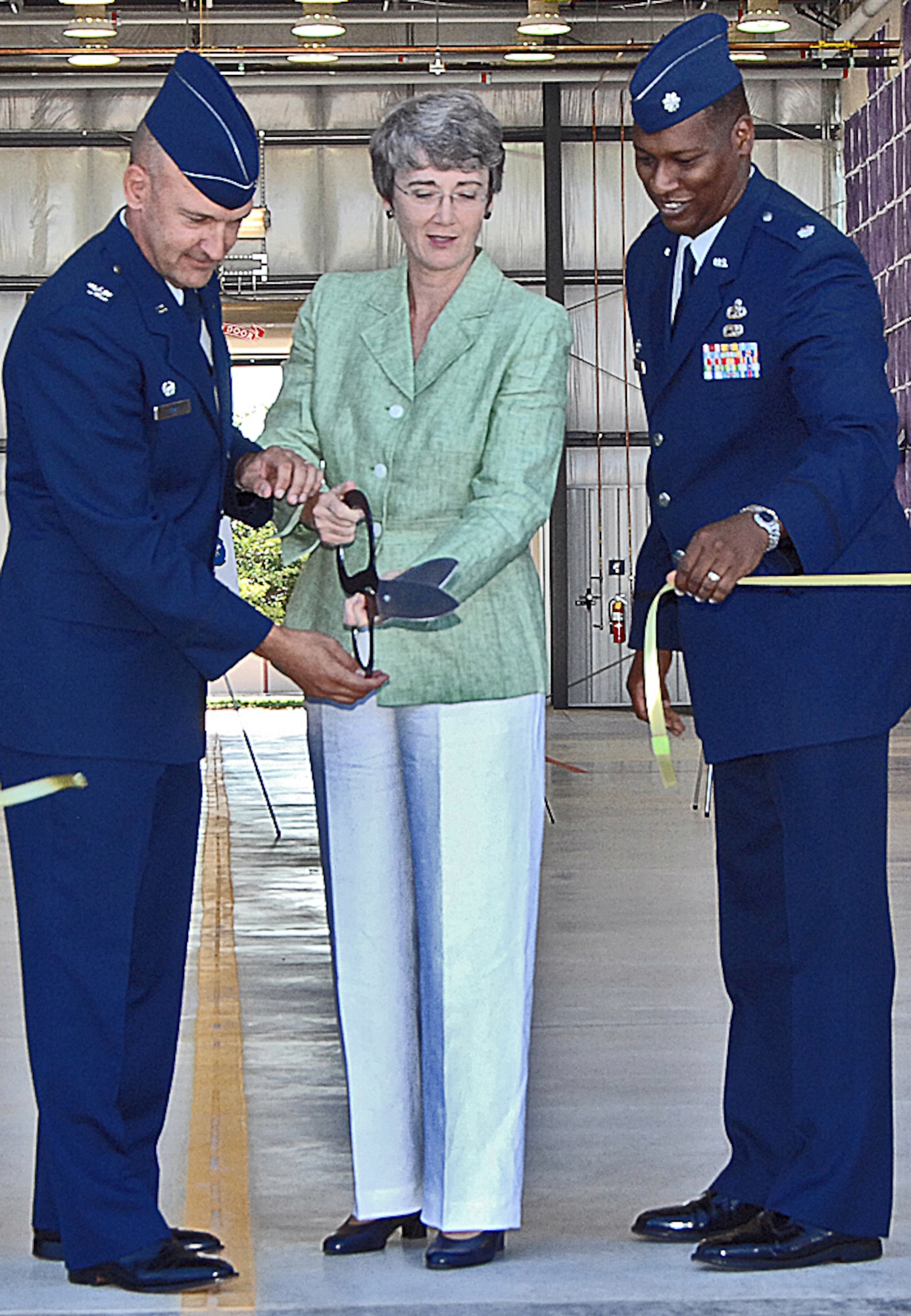 At the ribbon cutting for the new corrosion control facility here are, from left to right, Col. Eric Kivi, 58th SOW commander; Congresswoman Heather Wilson; and Lt. Col. Leon Dockery, 58th Maintenance Squadron commander. U.S. Air Force photo by Helga Carter
