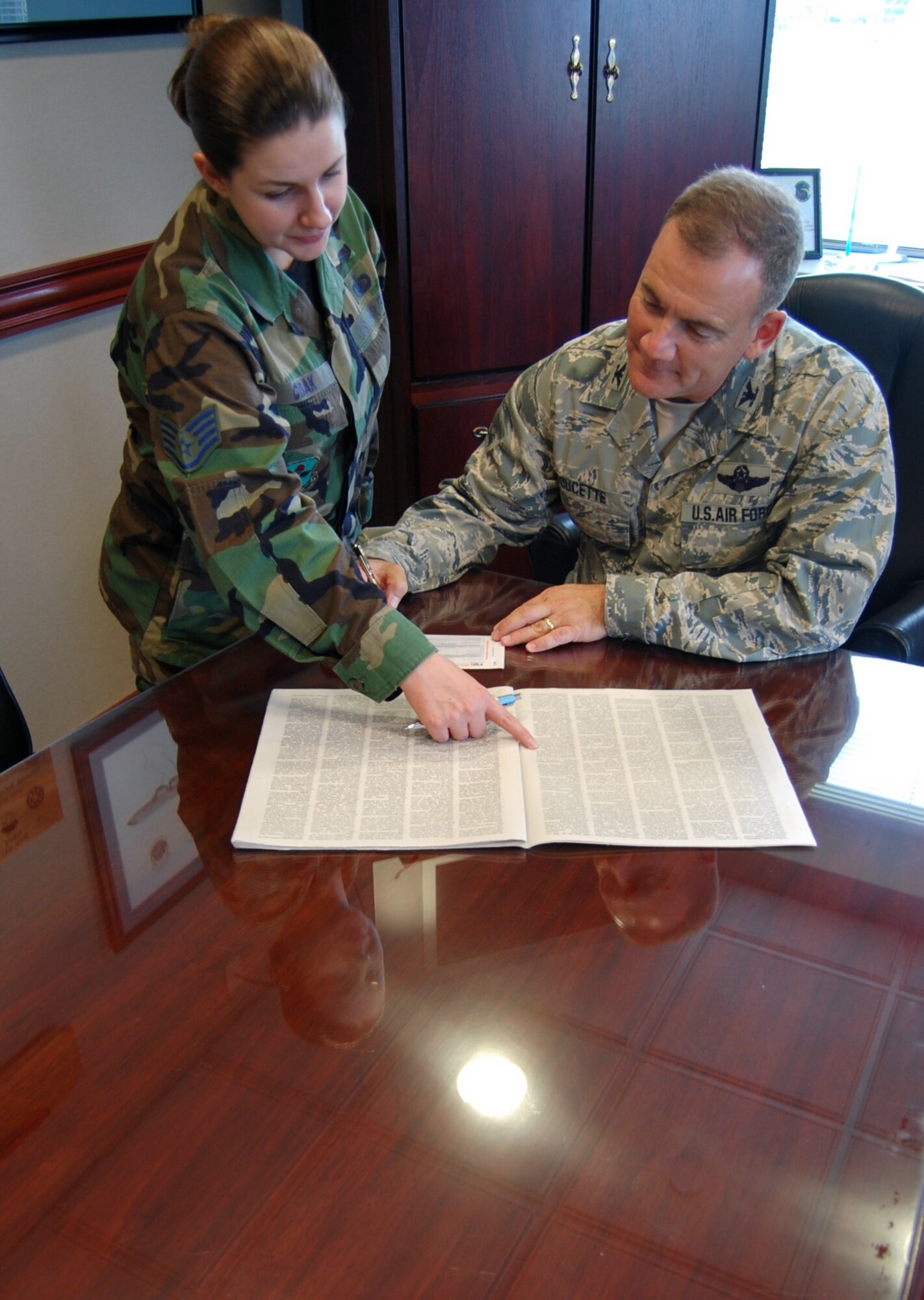 LAUGHLIN AIR FORCE BASE, Texas -- Col. John Doucette, 47th Flying Training Wing commander, signs a check for the Combined Federal Campaign here Sept. 9. (U.S. Air Force photo by Airman 1st Class Sara Csurilla)