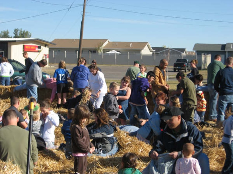 MINOT AIR FORCE BASE, N.D. -- Airmen, spouses and children from Minot AFB enjoy putting together scarecrows during last year's Fall Festival event here. This year's event, scheduled for Sept. 20 from 10 a.m. to 2 p.m. in the Shopette parking lot, will be the 10th year the 741st Missile Squadron has held the event. (Courtesy photo) 