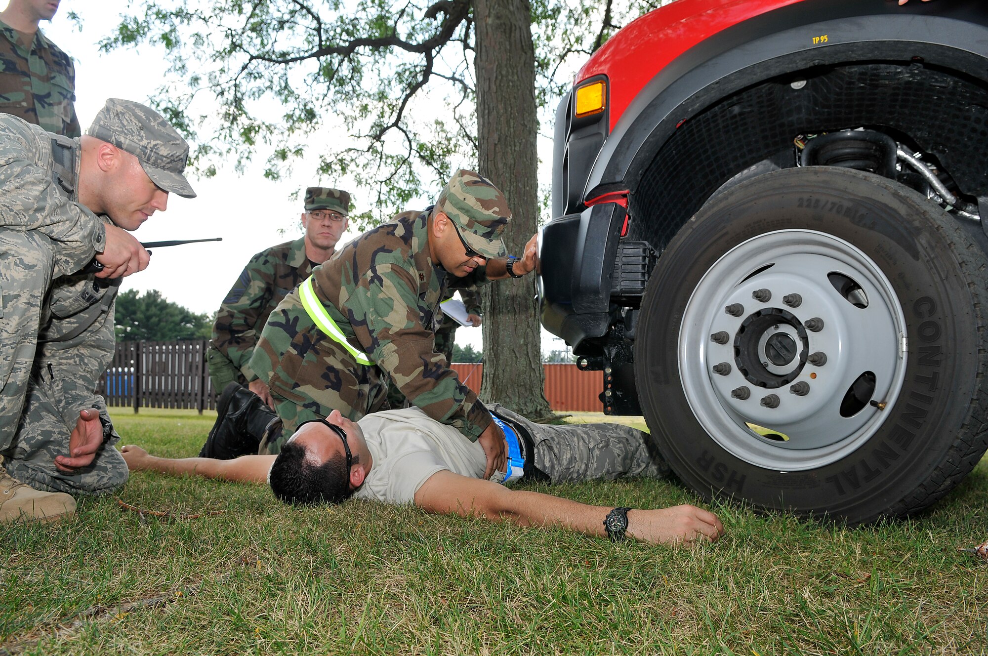 Maj. Niraj Govil, 305th Medical Group, performs an initial medical assessment on his patient, Staff Sgt. David Bernal, 514th Civil Engineer Squadron, during a mobility exercise here Sept. 8. Sergeant Bernal was injured in a simulated vehicle accident as one of the scenarios used in the exercise to help prepare McGuire personnel for the upcoming Operational Readiness Inspection. (U.S. Air Force photo/Kenn Mann)
