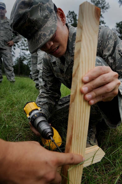 MOODY AIR FORCE BASE, Ga. – Airman 1st Class Diep Nguyen, 23rd Civil Engineer Squadron engineer specialist, screws a batter board onto a stake during training here Aug. 21. Airman Nguyen is training on how to set the finish grade for a floor of a facility. (U.S. Air Force photo by Senior Airman Gina Chiaverotti)
