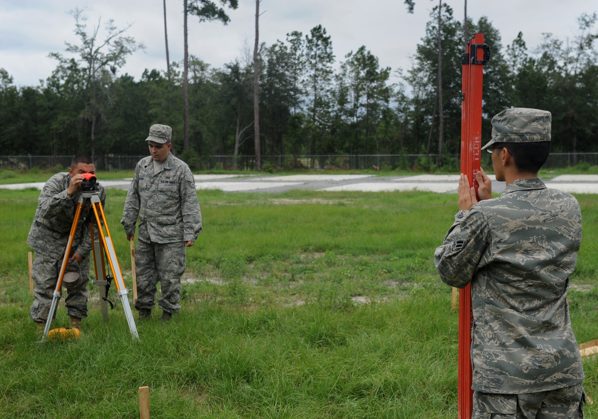 MOODY AIR FORCE BASE, Ga. – Airman 1st Class Mark Baldengro, 23rd Civil Engineer Squadron engineer specialist, uses an auto level to set a finish grade for the floor of a facility while Airman 1st Class Diep Nguyen, 23rd CES engineer specialist, holds a Philadelphia rod during training here Aug. 21. Airmen Baldengro and Nguyen are preparing for a deployment with the 820th Red Horse Squadron out of Nellis Air Force Base, Nev. (U.S. Air Force photo by Senior Airman Gina Chiaverotti)

