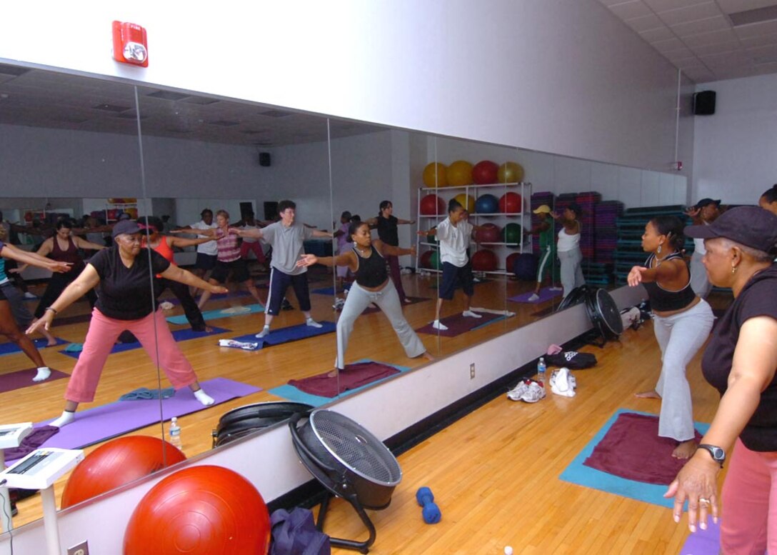 Students participate in the newest Yoga class to be offered on base Sept. 5.  The free Yoga class’s main purpose is to restore muscle group strength, tone, increase balance and breathing. The class is available to various age groups. (USAF photo by Bobby Jones)