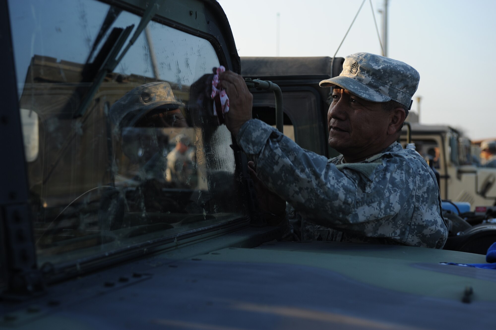DYESS AIR FORCE BASE, Texas - Sergeant First Class Sam Bernal, 1200th Infantry Battalion, clean the bugs off of the windows of his HM-V, in the Dyess  AFB fitness center parking lot, here,  Sept.  2.  SFC Bernal is attached to the New Mexico Army National Guard, in route to provide aid to Louisiana after Hurricane Gustav.  Dyess  airmen are ready and willing to assist and support sister service members whether active duty, guard or reserve. (U.S. Air Force photo/ Senior Airman Courtney Richardson)