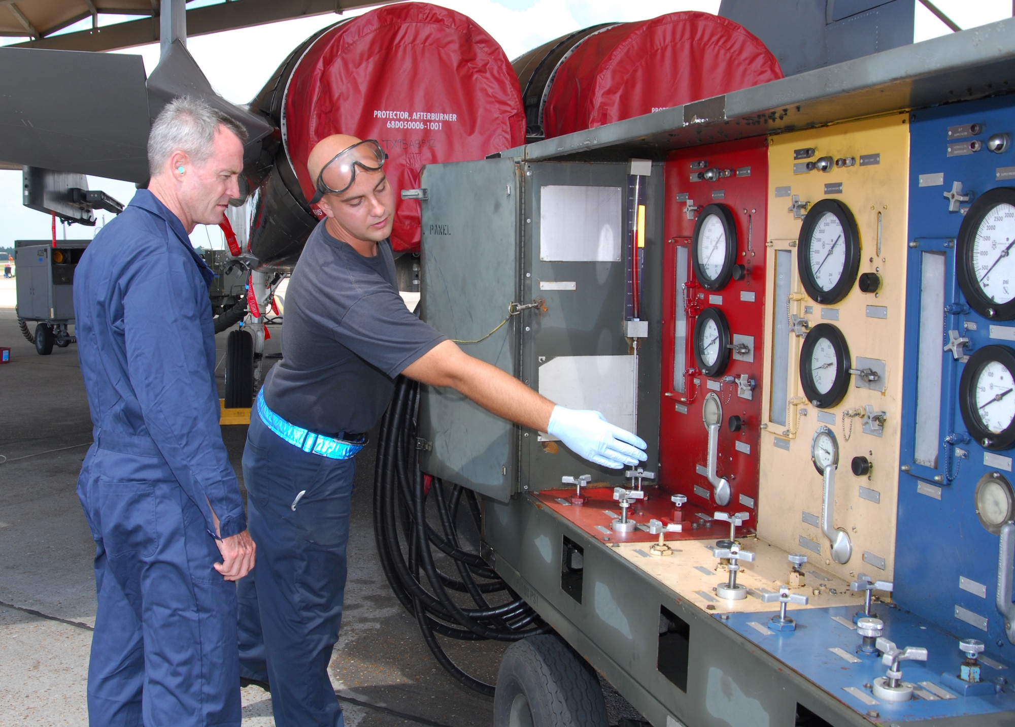 Airman 1st Class David Weeks, 95th Air Maintenance Unit F-15 avionics systems journeyman, shows Brig. Gen. Darryl Roberson, 325th Fighter Wing commander, how the hydraulic test stand works on the jets.  Airman Weeks, selected for the Commander’s Shadow Program, is responsible for maintaining the F-15 on-equipment avionic systems, inspecting, servicing and performing general handling procedures.  “Airman Weeks bleeds Air Force blue,” said Staff Sgt. Brent Wood, Airman Week’s supervisor and nominator. Serving the Air Force for two and a half years, Airman Weeks hails from Charlotte, N.C.  (U.S. Air Force photo by Lisa Norman)