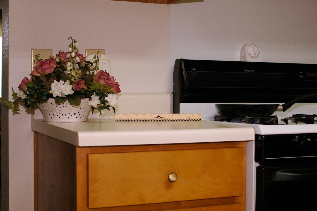 LANGLEY AIR FORCE BASE,Va -- Airman 1st Class Jonathan Koob illistrates how he keeps things that burn at least 12 inches away from a flame Sept. 9. Always blow out candles when you leave the room or go to sleep.  Candle fires accounted for an esimated four percent of all reported home fires in 2005. (U.S. Air Force photo/ Airman 1st Class Jonathan Koob)