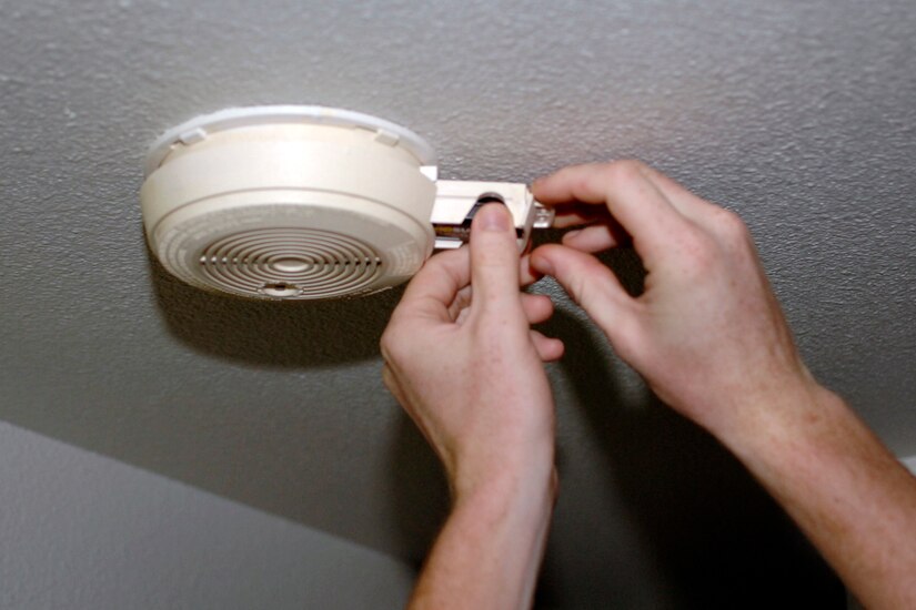 LANGLEY AIR FORCE BASE, Va -- Airman 1st Class Zachary Wolf replaces the batteries in a smoke alarm Sept. 9 . Test smoke alarms at least once a month and replace the batteries once a year or when the alarm "chirps" -- that lets you know the battery is low.  (U.S. Air Force photo/Airman 1st Class Jonathan Koob)