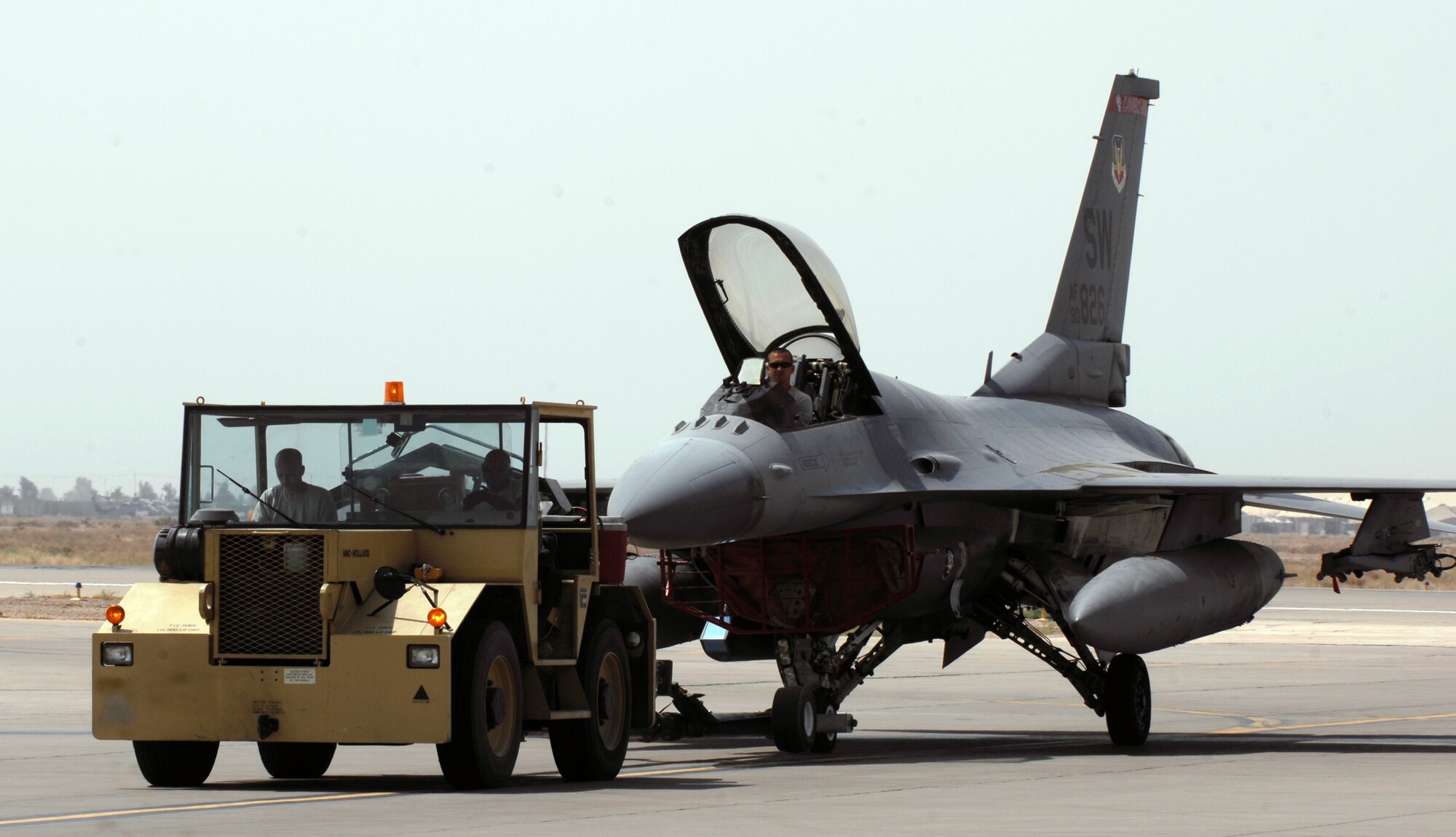 JOINT BASE BALAD, Iraq -- Airmen with the 77th Expeditionary Fighter Squadron here tow an F-16 Fighting Falcon assigned to the 77th EFS toward a hangar here Sept. 2. The F-16 is deployed from Shaw Air Force Base, S.C. (U.S. Air Force photo/Airman 1st Class Jason Epley)