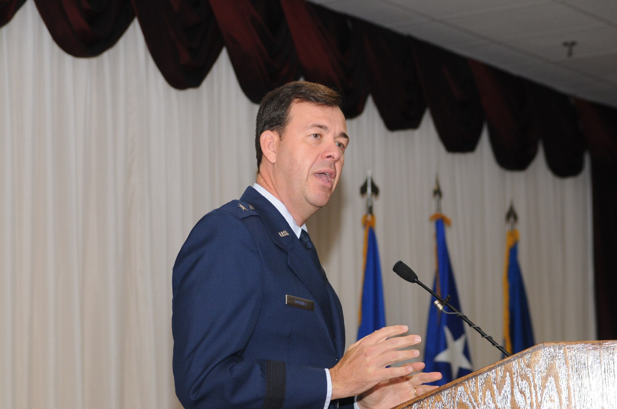 Brig. Gen. Greg Touhill, 81st Trainig Wing commander, gets promoted by Maj. Gen. Al Flowers, 2nd Air Force commander, during a ceremony at the Locker House Events Center  5 Sept. 08.  More than 100 people were in attendance including Biloxi mayor A.J. Holloway, local community leaders and leadership from across Keesler.  Also in attendance were General Touhill's  wife, Charlene and daughter Kate. 