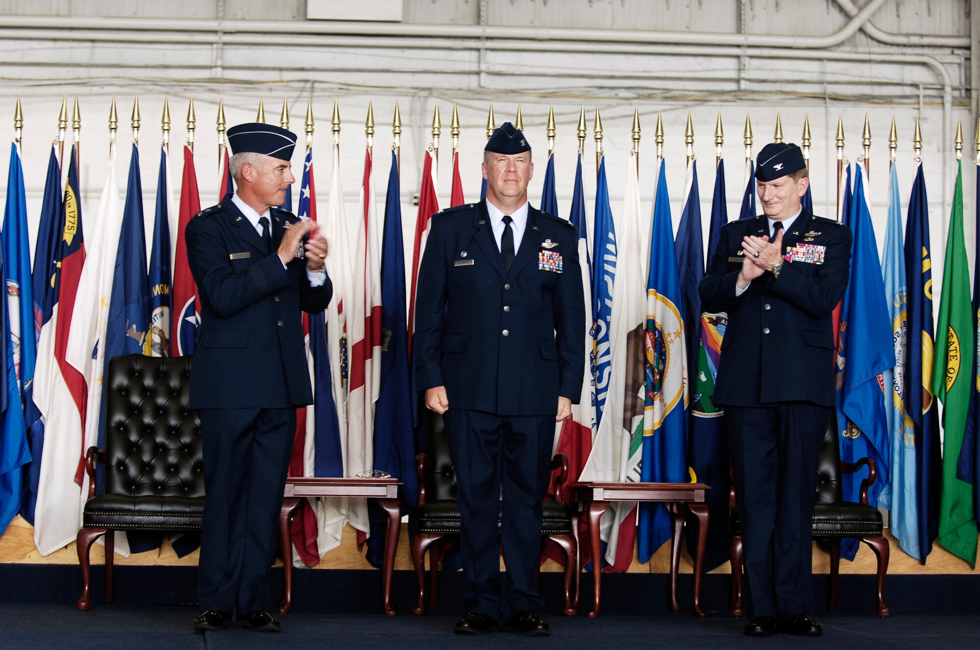 Maj. Gen. Winfield Scott III and Col. Robert Thomas applaud Col. Lawrence Martin after he accepts command of the 6th Air Mobility Wing Monday. Col. Thomas relinquished command of the wing during the ceremony  (U.S. Air Force photo/Tech. Sgt. Sean White)
