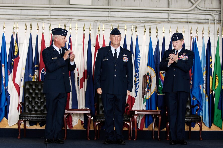 Maj. Gen. Winfield Scott III and Col. Robert Thomas applaud Col. Lawrence Martin after he accepts command of the 6th Air Mobility Wing Monday. Col. Thomas relinquished command of the wing during the ceremony  (U.S. Air Force photo/Tech. Sgt. Sean White)
