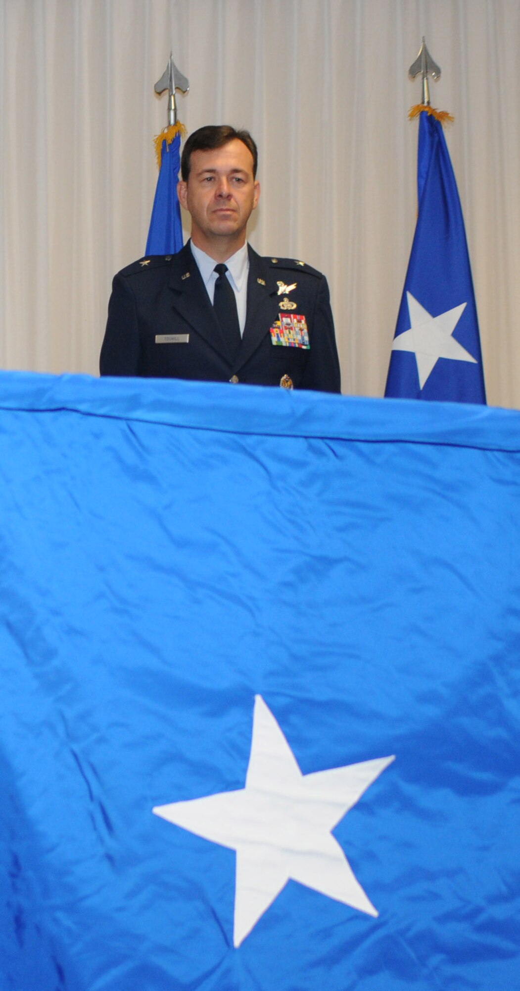 Brig. Gen. Greg Touhill, 81st Trainig Wing commander, gets promoted by Maj. Gen. Al Flowers, 2nd Air Force commander, during a ceremony at the Locker House Events Center  5 Sept. 08.  More than 100 people were in attendance including Biloxi mayor A.J. Holloway, local community leaders and leadership from across Keesler.  Also in attendance were General Touhill's  wife, Charlene and daughter Kate. 