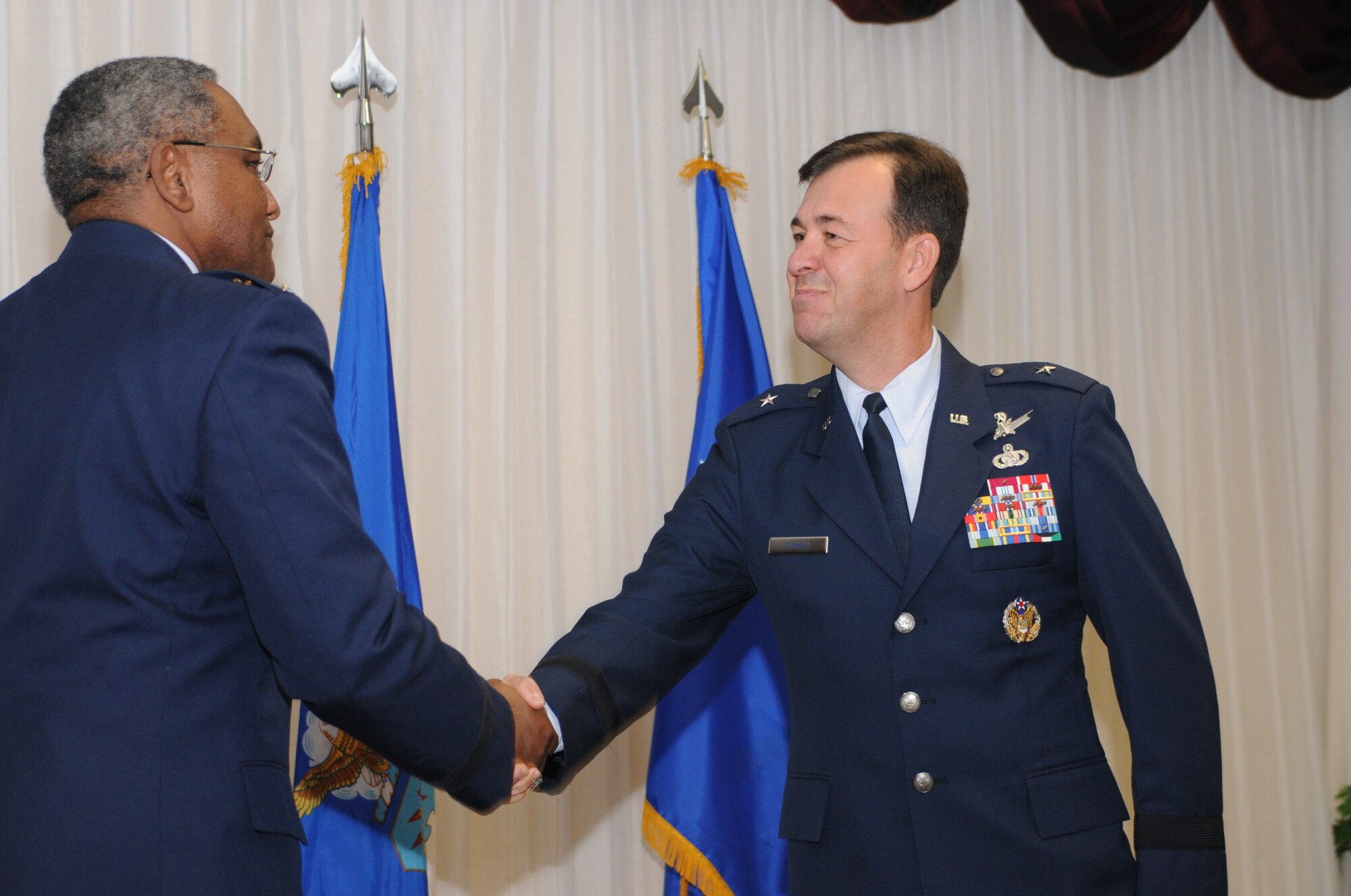 Brig. Gen. Greg Touhill, 81st Trainig Wing commander, gets promoted by Maj. Gen. Al Flowers, 2nd Air Force commander, during a ceremony at the Locker House Events Center  5 Sept. 08.  More than 100 people were in attendance including Biloxi mayor A.J. Holloway, local community leaders and leadership from across Keesler.  Also in attendance were General Touhill's  wife, Charlene and daughter Kate. 