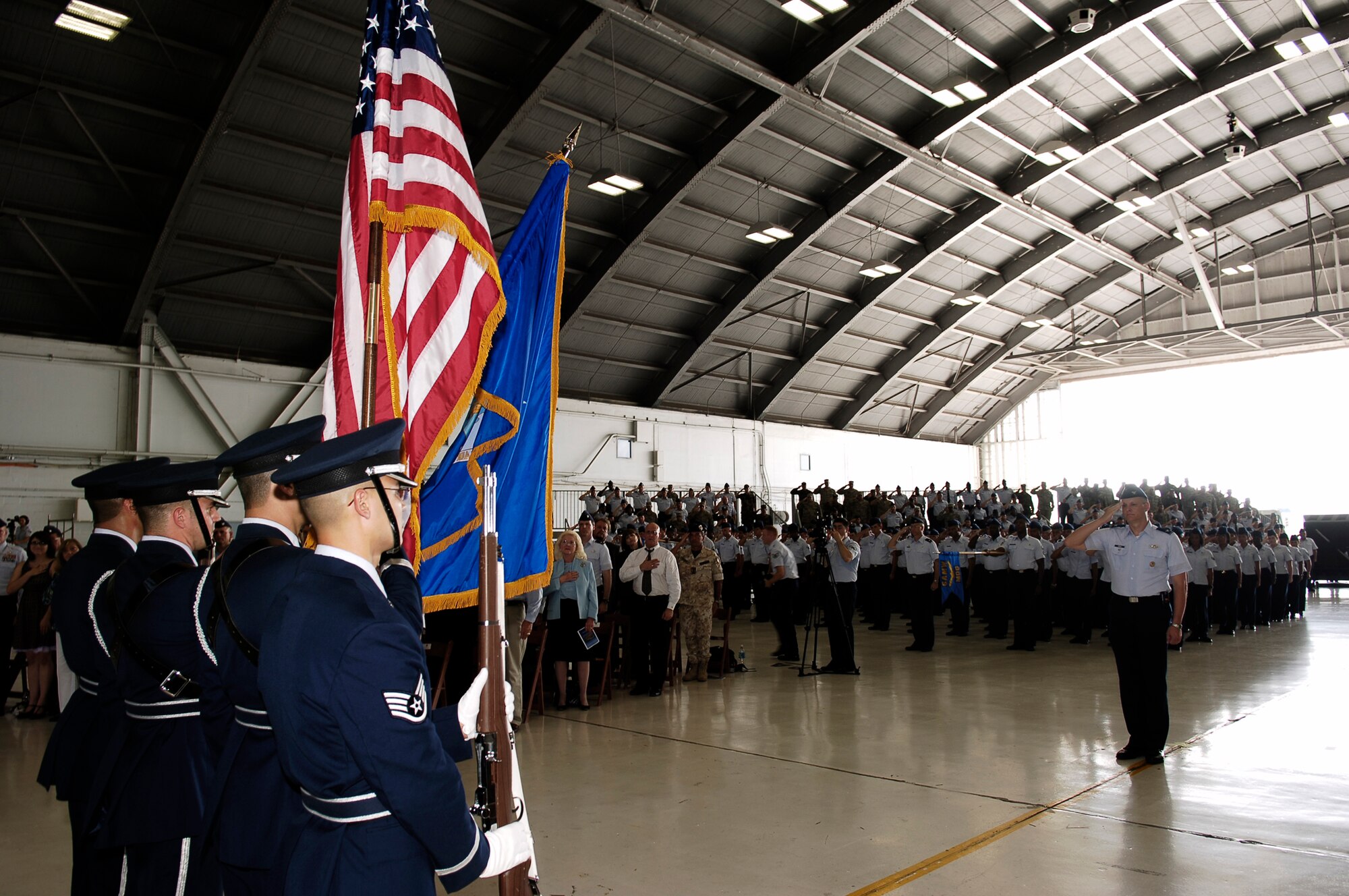 Members of MacDill Air Force Base, Fla., and the Tampa Bay community stand for the National Anthem Monday during a change of command ceremony for the 6th Air Mobility Wing. Col. Robert Thomas relinquished command to Col. Lawrence Martin. (U.S. Air Force photo/Tech. Sgt. Sean White)
