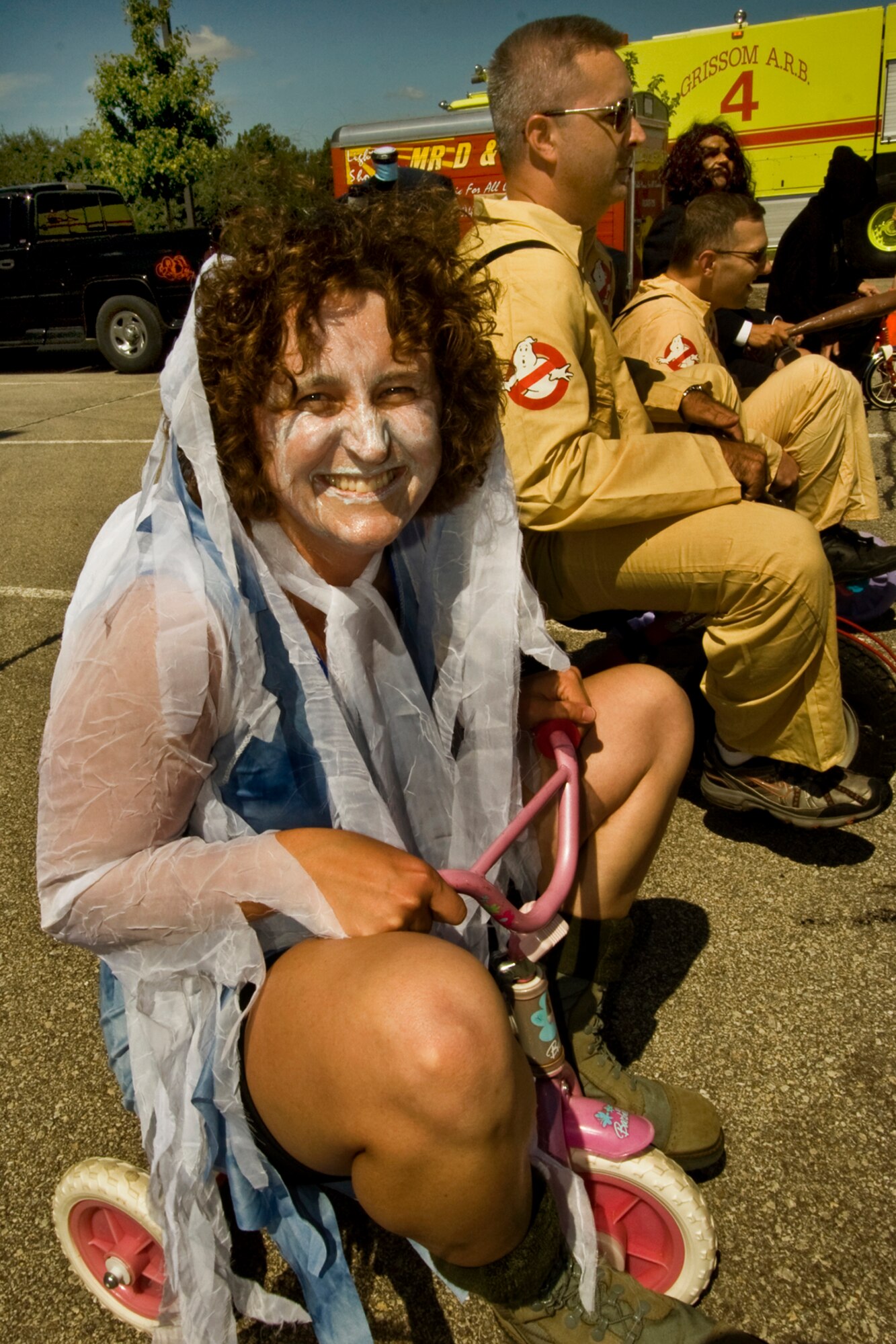 GRISSOM AIR RESERVE BASE, Ind., -- Maj. Rebecca Fox, 434th Communications Squadron commander, is all set to begin the commander's tricycle race during the September unit training assembly. Major Fox was dressed as a ghost and competed with a pair of Ghost Busters, Maj. Tim Bartlett, 434th Aircraft Maintenance Squadron commander, center, and Maj. Michael Polomchak, 434th Maintenance Operations Flight commander. (U.S. Air Force photo/Tech. Sgt. Patrick Kuminecz)