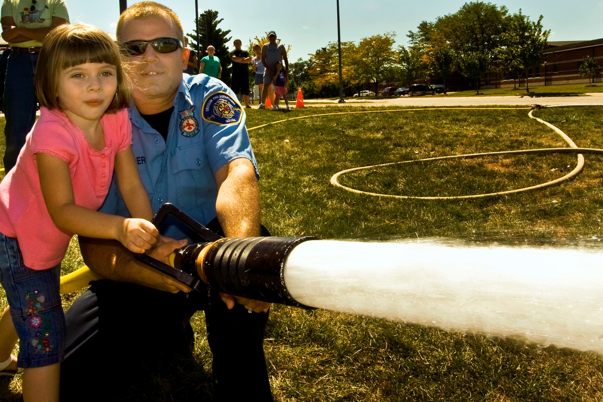 GRISSOM AIR RESERVE BASE, Ind., -- A youngster is shown how to work a firehose by base firefighter Ben Nestander during the annual family day picnic held during the September unit training assembly.  (U.S. Air Force photo/Tech. Sgt. Patrick Kuminecz)   