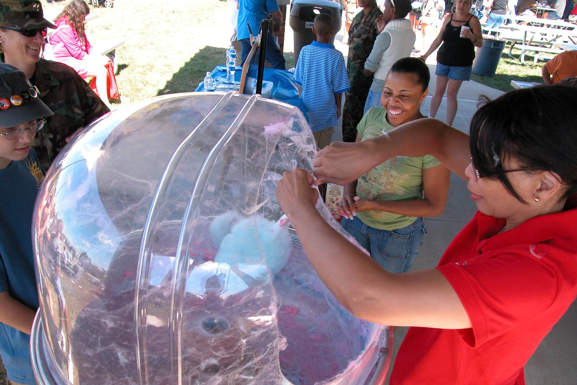GRISSOM AIR RESERVE BASE, Ind., -- Master Sgt. Trudy Burnett, a chaplains assistant with the 434th Air Refueling Wing, makes cotton candy for customers during the annual family day picnic. The booth was manned by members of the Rising Six organization. (U.S. Air Force photo/Staff Sgt. Chris Bolen)