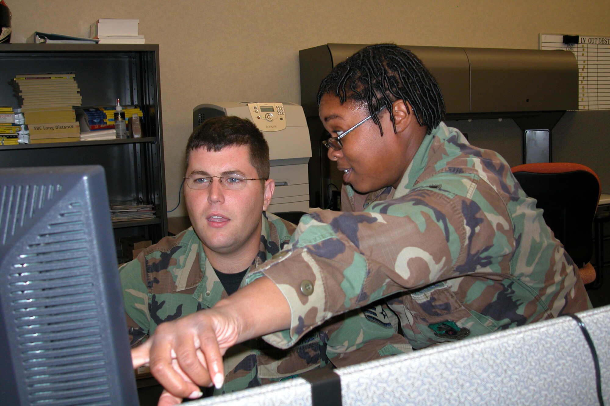 GRISSOM AIR RESERVE BASE, Ind., -- Staff Sgt. Charlene Howard, works with Tech. Sgt. Brett Jaynes, as they try to assist a customer while working in the help desk area of the 434th Communications Squadron. (U.S. Air Force photo/Staff Sgt. Chris Bolen)
