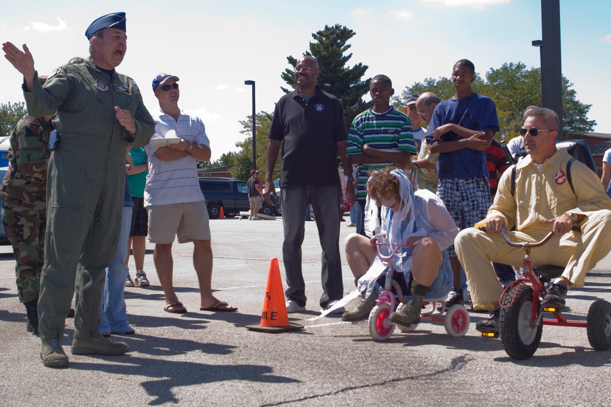GRISSOM AIR RESERVE BASE, Ind., -- Brig. Gen. Dean Despinoy, 434th Air Refueling Wing commander, far left, signals the start of the annual commander's tricycle race as part of the family day picnic activities. Maj. Rebecca Fox, 434th Communications Squadron commander, is dressed as a ghost, and Maj. Tim Bartlett, 434th Aircraft Generation Squadron commander, is a Ghost Buster. (U.S. Air Force photo/Staff Sgt. Ben Mota)