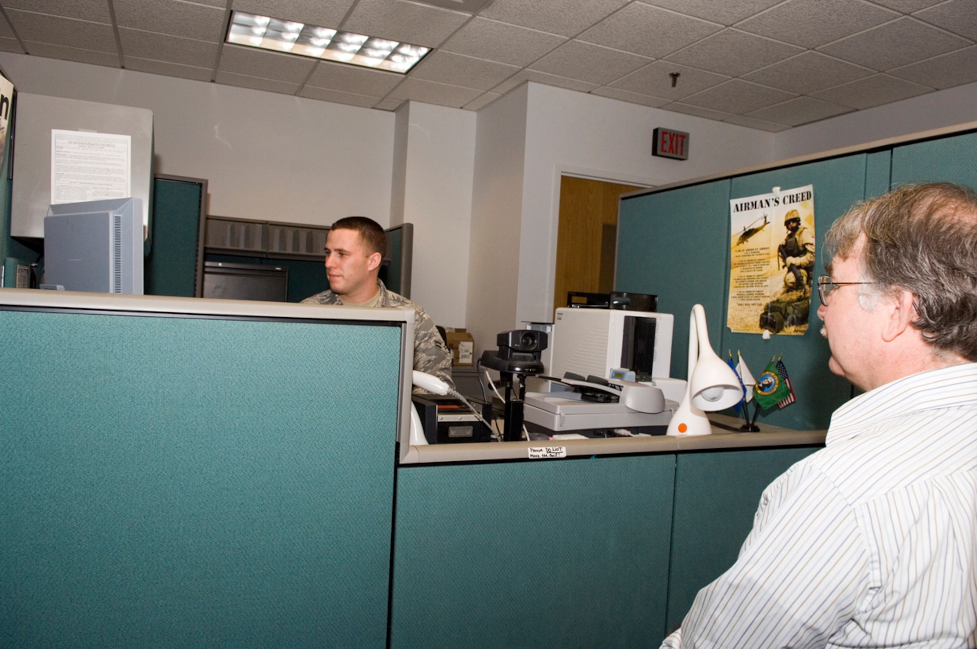 HANSCOM AFB, Mass. -- Airman 1st Class Justin Peattie, 66th Mission Support Squadron, Military Personnel Flight customer service technician, makes a new Common Access Card for a customer, Sept. 9. A number of improvements were implemented in the MPF to better meet customer needs, including extending office hours. The office, located on the first floor of the Brown Building, building 1305, is now open 8 a.m. to 3 p.m., on weekdays. (U.S. Air Force photo by Rick Berry)