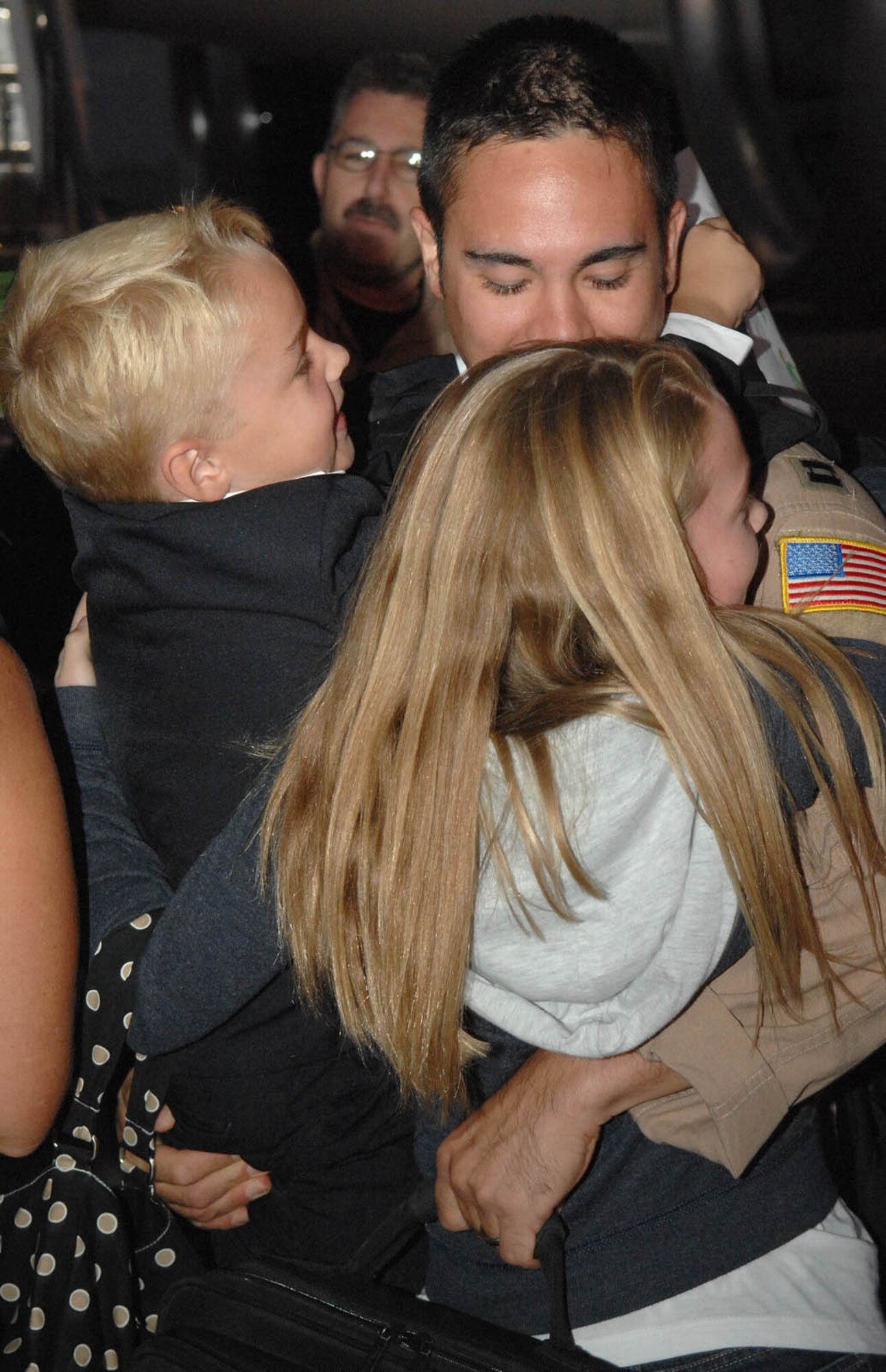 Capt. Dave Fink, 55th Rescue Squadron, gets a warm welcome from his kids Shelby, 11, and Garrett, 7, here Sept. 6, after returning home from Iraq.  The return brought home more than 120 Airmen from the 55th Rescue and the 563rd Maintenance Squadron home after their four month deployment.  Captain Fink is a HH-60 helicopter pilot for the 55th RQS.  (U.S. Air Force Photo by Senior Airman Jacqueline Romero)