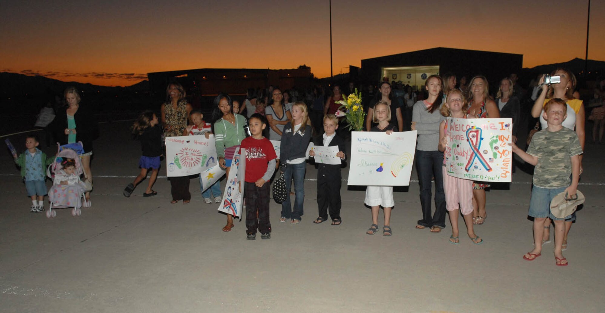 Family members from the 55th Rescue Squadron and the 563rd Maintenance Squadron wait for their loved ones to get off the airplane here Sept. 6. One hundred and twenty eight Airmen were returning from a four month deployment to Iraq.  (U.S. Air Force Photo by Senior Airman Jacqueline Romero)