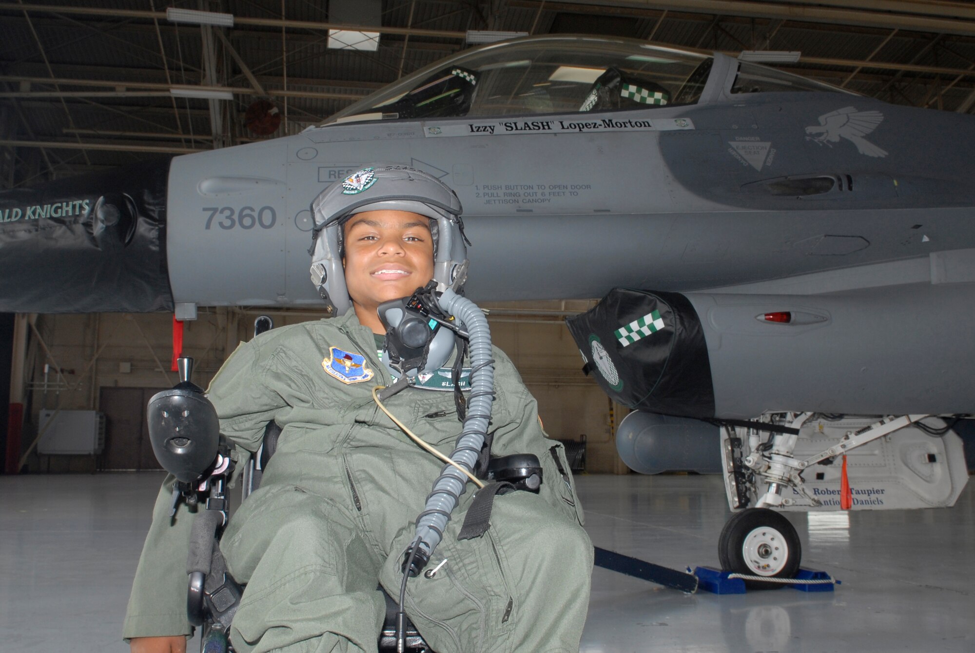 Izzy "Slash" Lopez-Morton, pilot-for-a-day, poses in front of his jet Aug. 26 after visiting Luke to learn what it's like to be an F-16 fighter pilot.