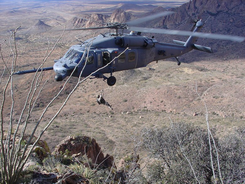 A 55th Rescue Squadron HH-60G practices high angle hoist work with a 48th RQS pararescuemen. (U.S. Air Force photo by Staff Sgt. Francis Reiley