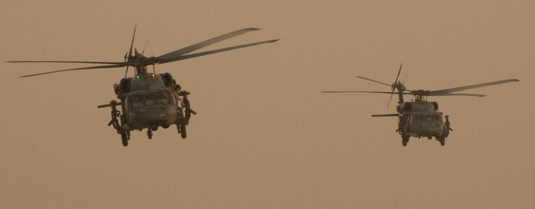 A pair a HH-60G Pave Hawks from the 55th Expeditionary Rescue squadron depart from a deployed location on a mission to support coalition troops.  (U.S. Air Force photo by Capt. Jay  Humprey)