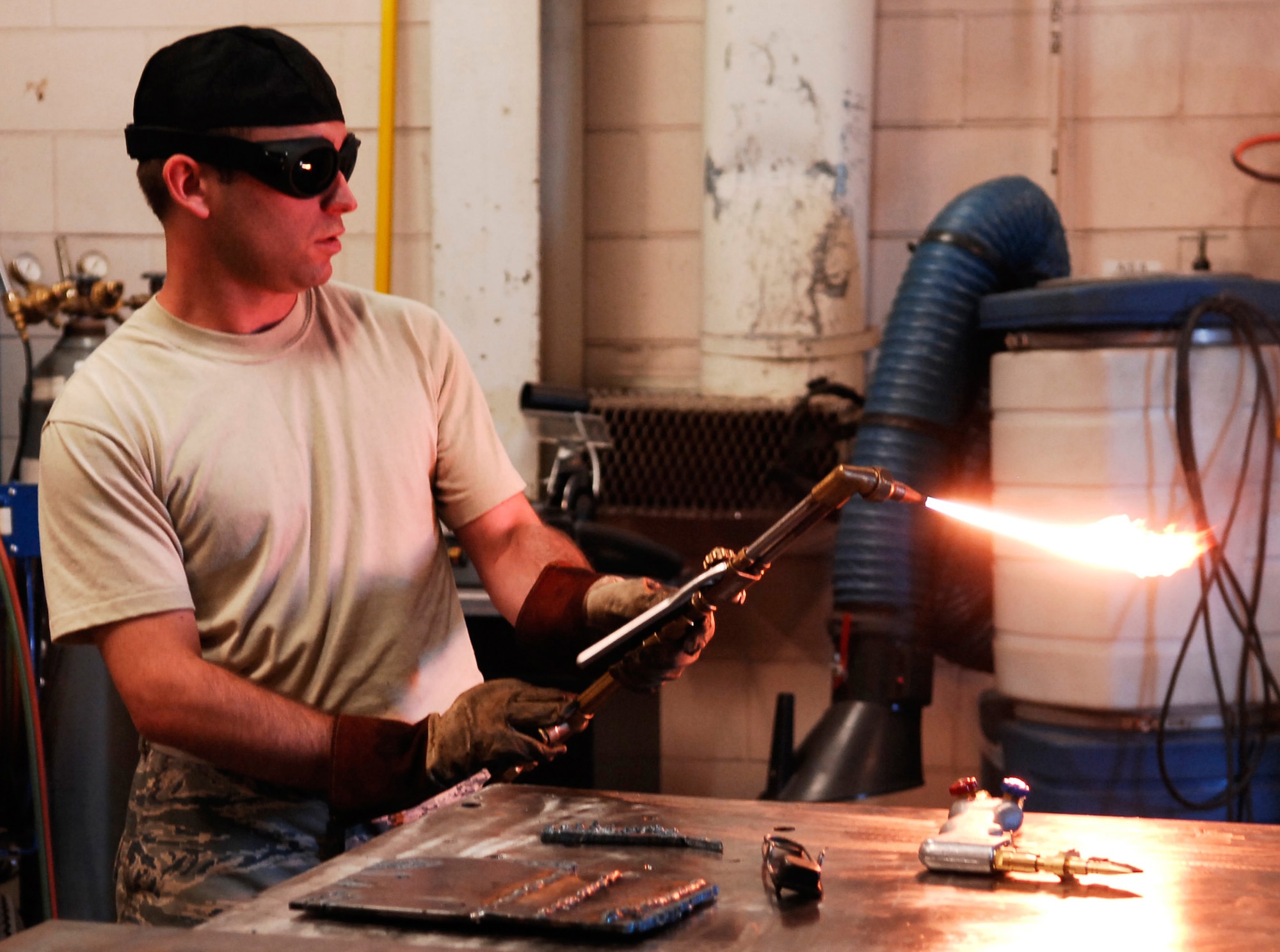 CANNON AIR FORCE BASE, N.M. - Staff Sgt. Justin Darland, 27th Special Operations Equipment Maintenance Squadron, gets the oxy-acetylene torch ready for a demonstration to wing leadership Sept. 5. The demonstration showed the differences between the old torch that Darland is using and the new torch, shown on the table in the foreground. (U.S. Air Force photo/Airman 1st Class Evelyn Chavez)