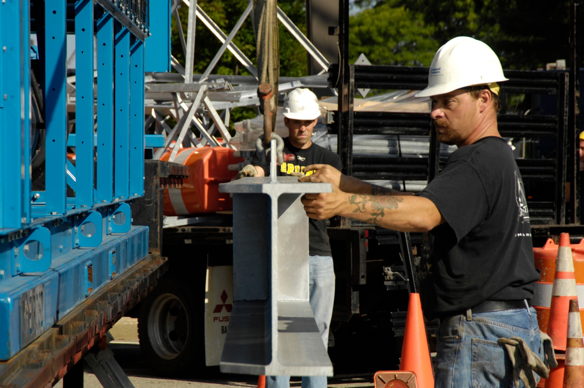 HANSCOM AFB, Mass. – Contractors move sections of a radio tower by crane from a flatbed truck, to be positioned onto the roof of Building 1624 as part of the Hanscom Land Mobile Radio relocation project. The towers are being relocated from Building 1119 to Building 1624 to improve radio communications on the base. (U.S. Air Force photo by Linda LaBonte Britt)