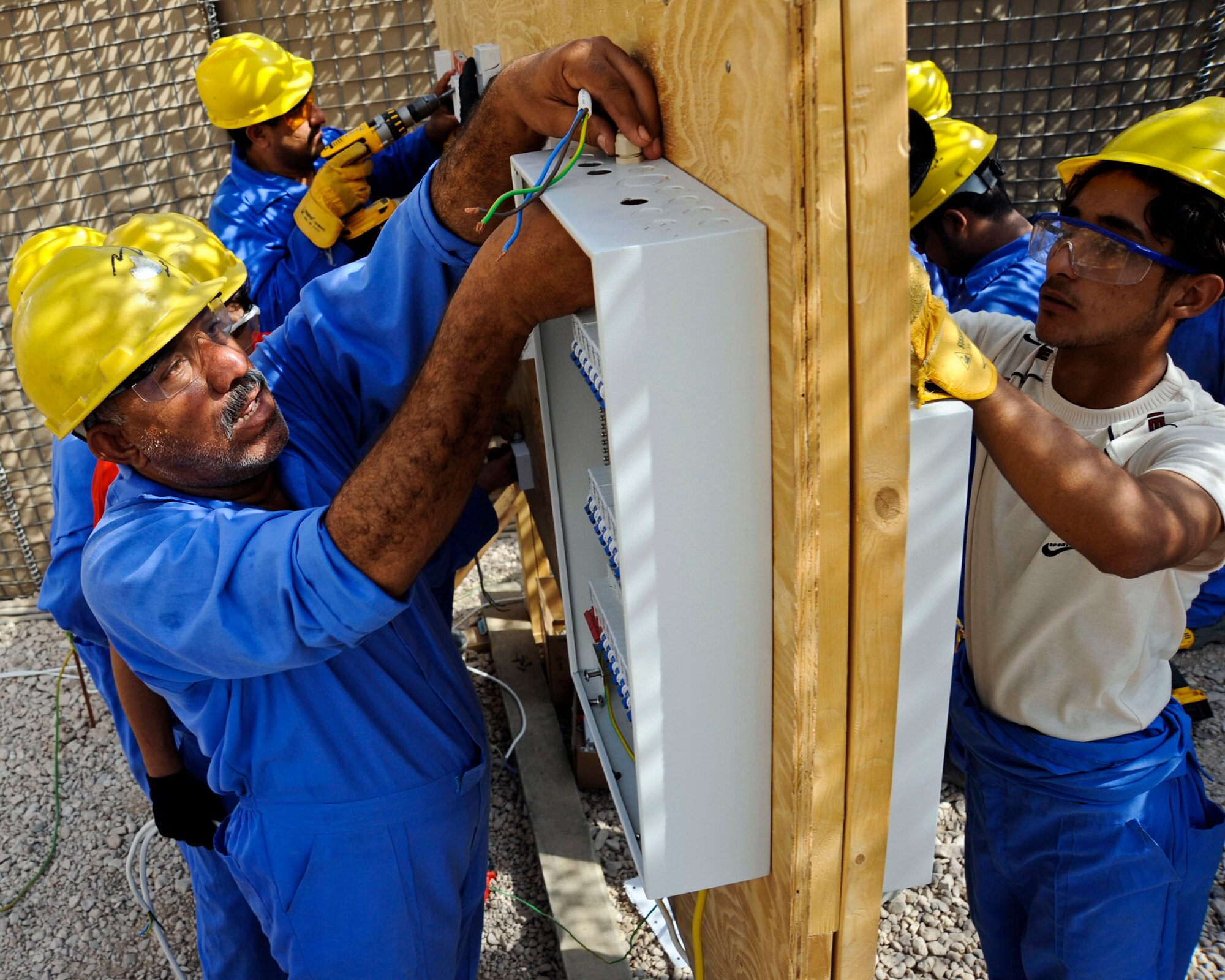 Iraqi student workers in the electrical training course wire-up an electrical panel during their final performance exam at Hawr Rajab, Iraq on Aug. 26. The course is apart of the Village of Hope program and is designed for former Sons of Iraq and Concerned Local Citizens to receive a trade that will help get them a job and rebuild their city that was battle damaged by al-Qaida in 2007. (U.S. Air Force photo/Staff Sgt. Paul Villanueva II)