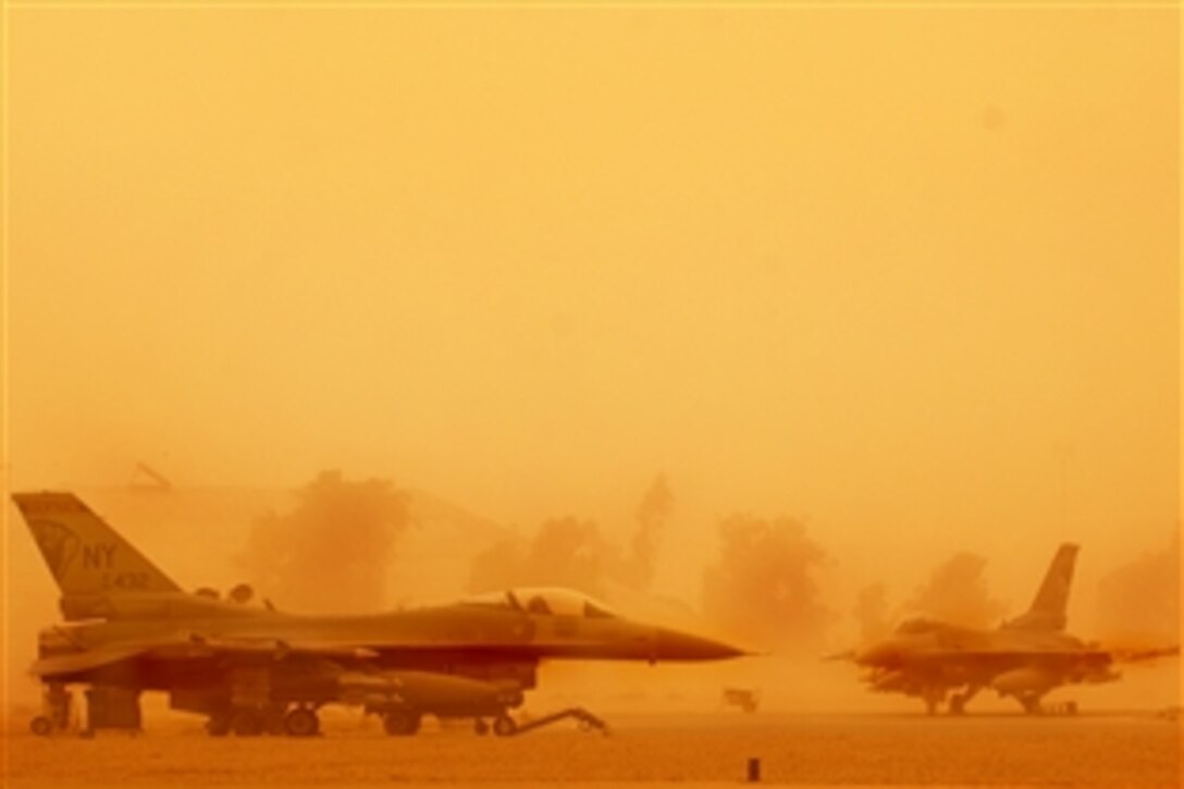 Two Fighting Falcons wait out a haboob on Joint Base Balad, Iraq, Sept. 9, 2008. Haboobs are sandstorms that result from the collapse of thunderstorms and the resulting downdrafts. The dust carried by a haboob can rise several kilometers in the sky, and winds can travel upwards of 30 mph. 