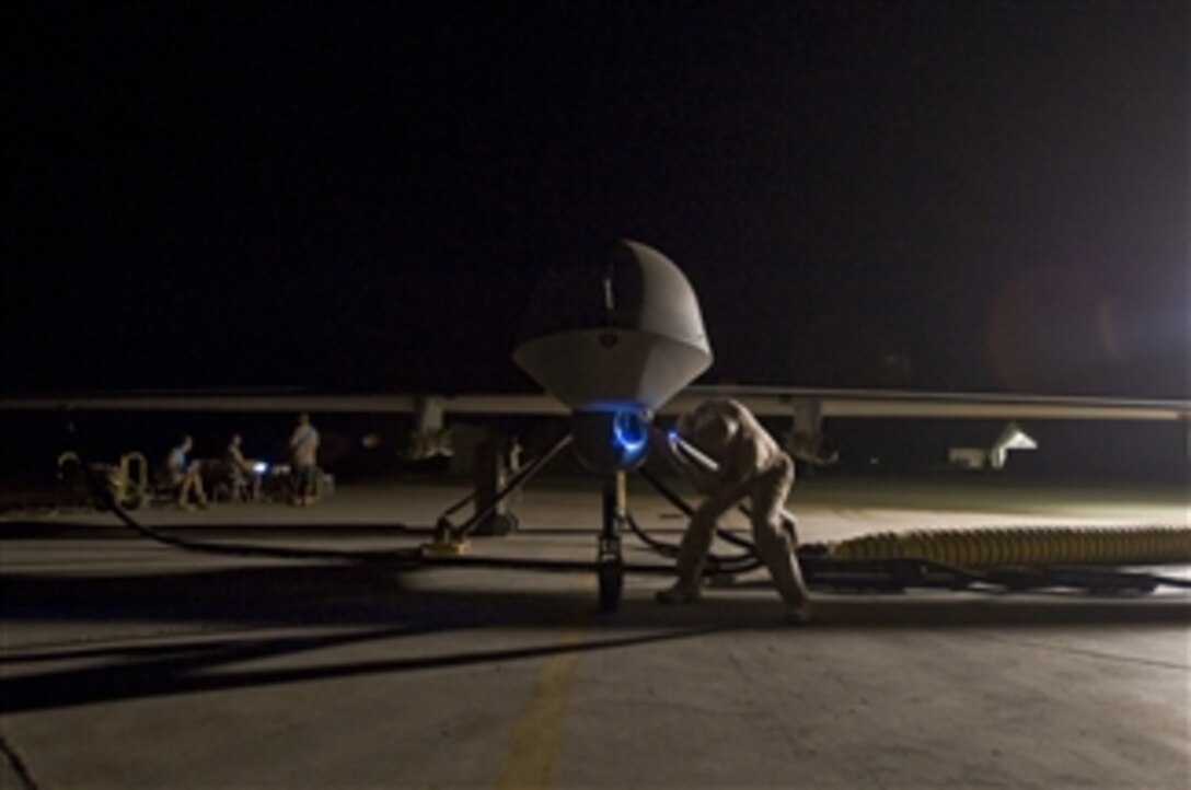 Commander of the 46th Expeditionary Reconnaissance Attack Squadron Lt. Col. Geoffrey Barnes performs a pre-flight inspection of an MQ-1B Predator unmanned aircraft at Ali Base, Iraq, on Sept. 3, 2008.  The Predator is a medium-altitude, long-endurance, remotely piloted aircraft.  
