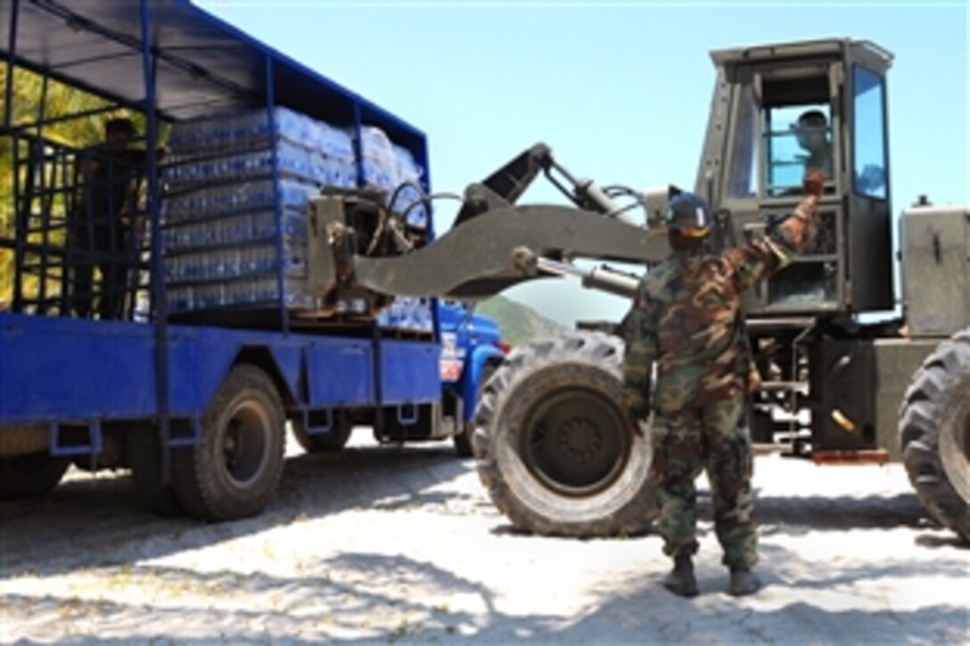 U.S. Navy sailors from USS Kearsarge move pallets of water as they prepare to depart from Santa Marta, Colombia, Sept. 6, 2008. The USS Kearsarge has been redirected from its current mission in Colombia to provide disaster relief support to communities in Haiti hit by Hurricane Ike and tropical storms Gustav and Hanna. 