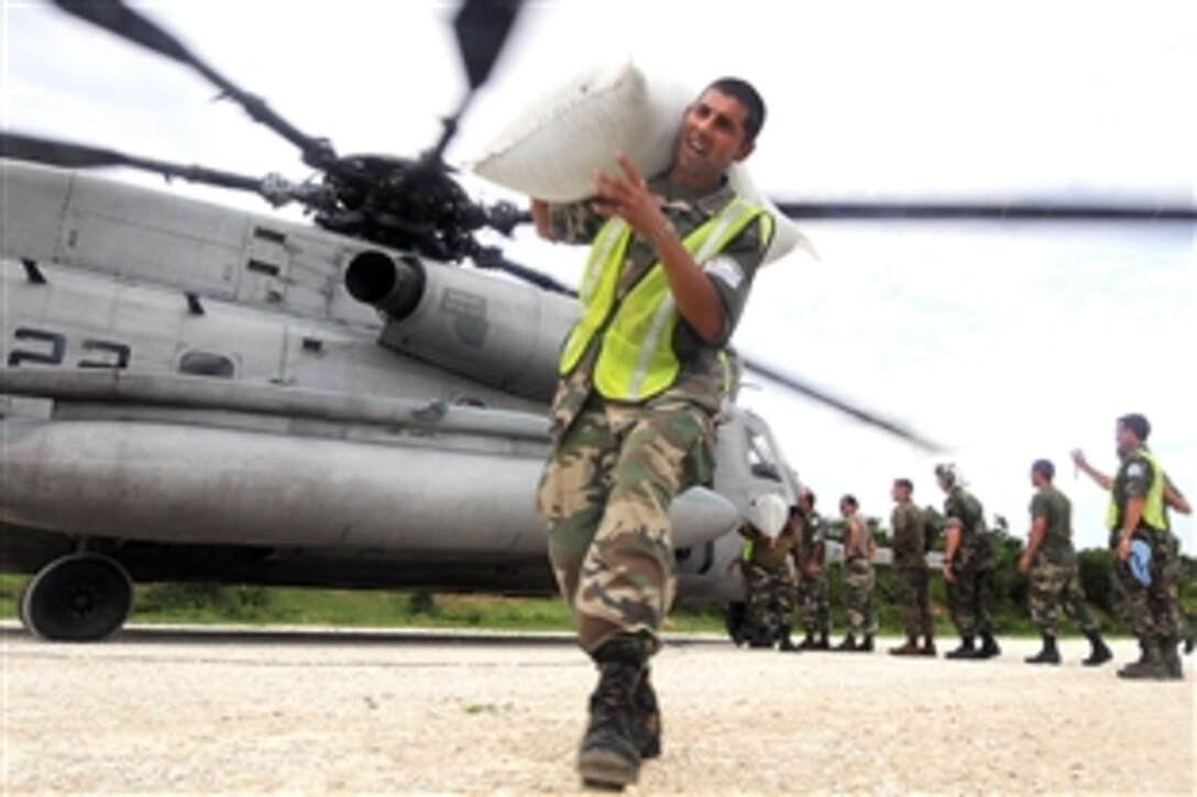 U.S. troops offload supplies to provide disaster relief in areas hit by recent tropical storms in Haiti, Sept. 8, 2008. The amphibious assault ship USS Kearsarge was diverted from Continuing Promise 2008, a humanitarian mission in the western Caribbean, to help in Haiti. 