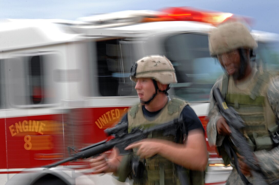 (Left) Airman 1st Class Jeff Gordon and Senior Airman Steven Oliver, 28th Security Forces military police officers, run to perform Self-Aid and Buddy Care on exercise role-players during an anti-terrorism exercise here Sept. 10. The exercise role-players simulated injuries that would happen in a real-life explosion. (U.S. Air Force photo by Airman Corey Hook)