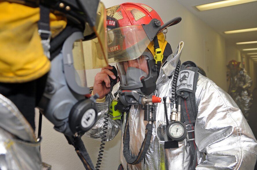 Fire fighters from the 28th Civil Engineer Squadron perform a search of the Rushmore Inn dormitory during an anti-terrorism force protection exercise on Sept. 10. The simulated fires were caused by a simulated explosion.  (U.S. Air Force photo/Senior Airman Marc I. Lane)
