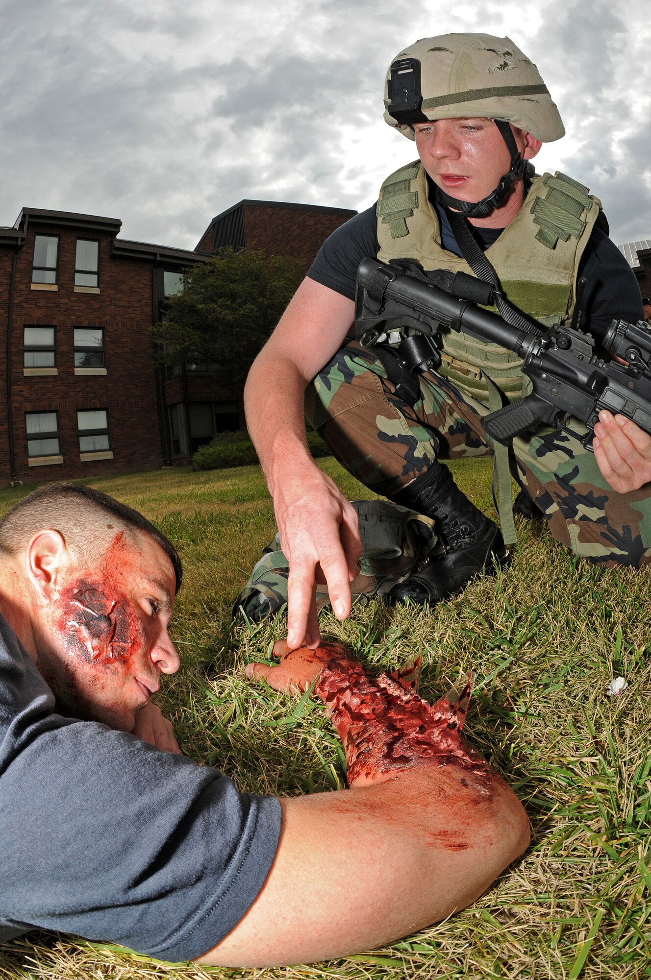 Airman 1st Class Jeffrey Gordon, 28th Security Forces Squadron police officer, checks  for possible head injury while administering Self-Aid and Buddy Care to Senior Airman Charles Stiles during an anti-terrorism force protection exercise on Sept. 10. Airman stiles simulated symptoms of burns and imbedded shrapnel suffered from an explosion. (U.S. Air Force photo/Senior Airman Marc I. Lane)

