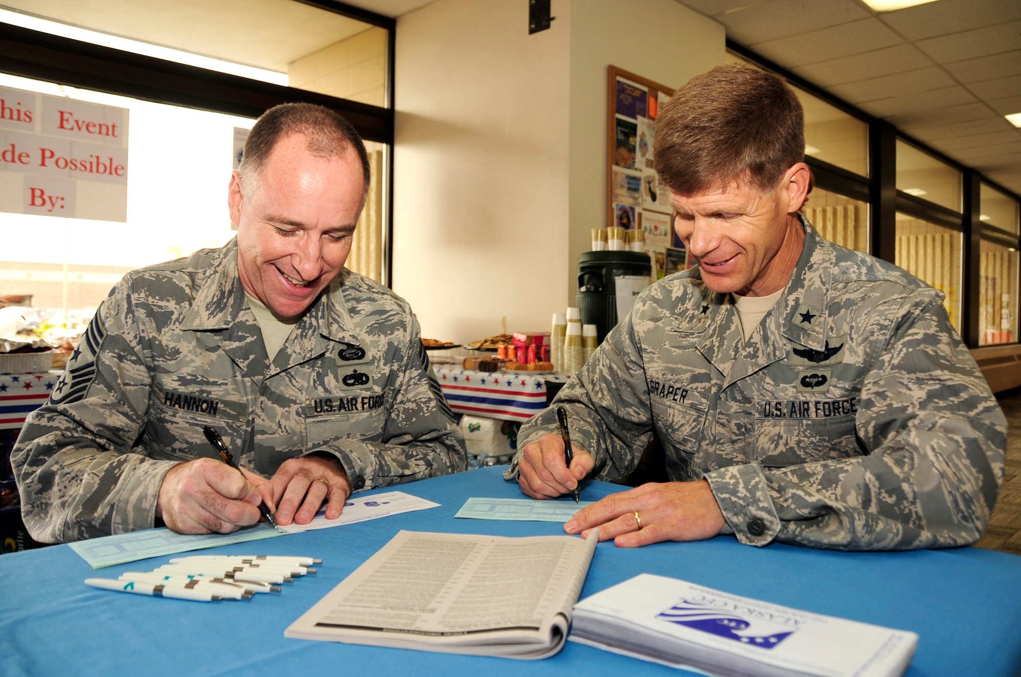 354th Fighter Wing Commander, Brig. Gen. Mark W. Graper and Command Chief Master Sgt. Earl A. Hannon fill out their Combined Federal Campaign fund forms during the annual CFC kickoff here, Sept. 10, 2008.  The CFC is the world's largest and most successful annual workplace charity campaign. Pledges made by Federal civilian, postal and military donors during the campaign season (Sept. 1 - Dec. 15) support eligible non-profit organizations that provide health and human service benefits throughout the world. Last year Eielson raised more than $101k for the CFC. For more information on the CFC, contact Capt. Marissa Carlton at 377-7208. (U.S. Air Force photo/Staff Sgt Tia Schroeder)