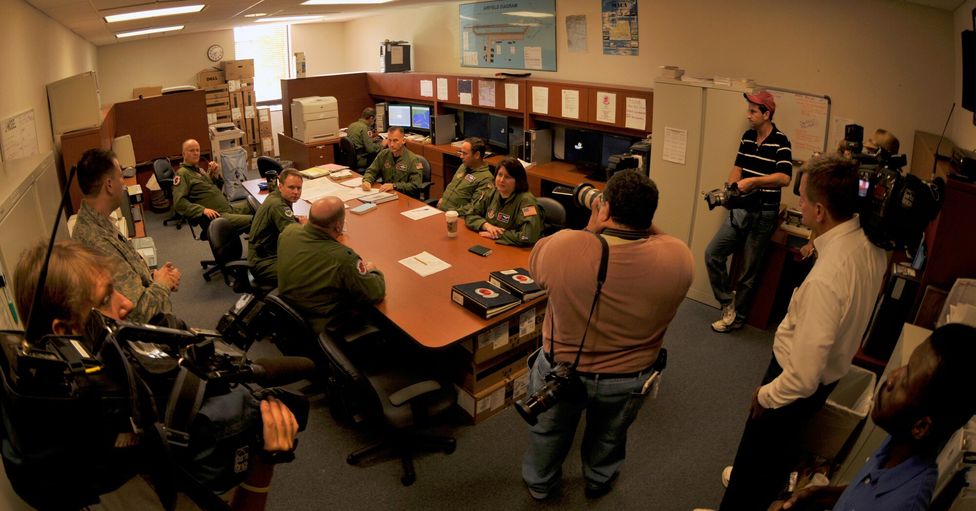 While the aircrew briefs for a mission into Hurricane Ike, news media representatives document the moment. The crew of Reservists left withj reporters from the Associated Press, WKRG and WVTM  onboard at 10:30 a.m. to locate the center of Ike and to gather data used by forecasters at the National Hurricane Center to better predict the path and intensity of storms. (U.S. Air Force Photo/Tech. Sgt. James B. Pritchett)
