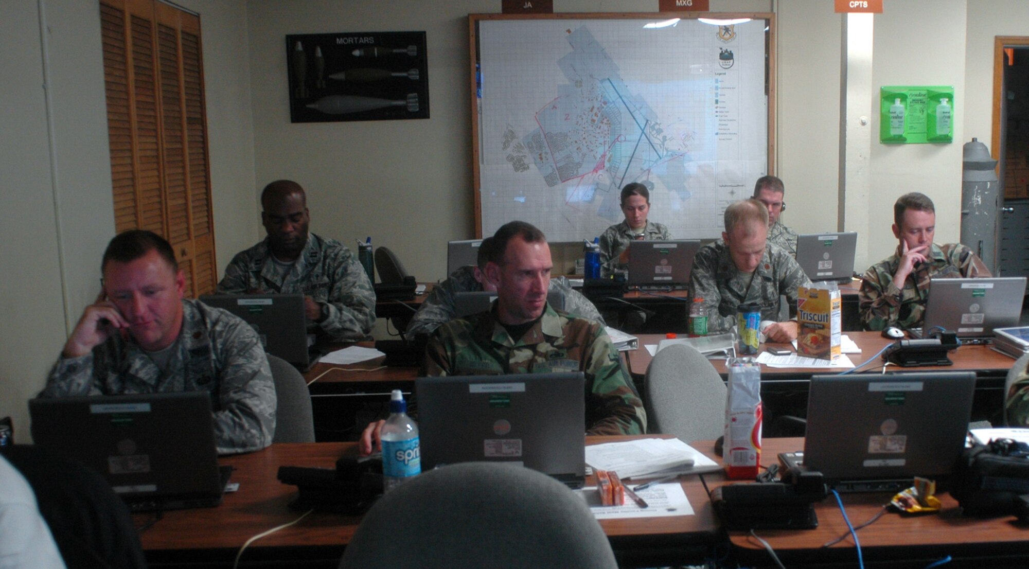 Emergency operation center members at Charleston AFB coordinate the base's response to Tropical Storm Hanna Sept. 5. Charleston AFB evacuated 11 C-17s, secured equipment outside and accounted for all wing personnel to include active duty, and reserve Airmen, civilians and family members. (U.S. Air Force photo/Staff Sgt. Sam Hymas)