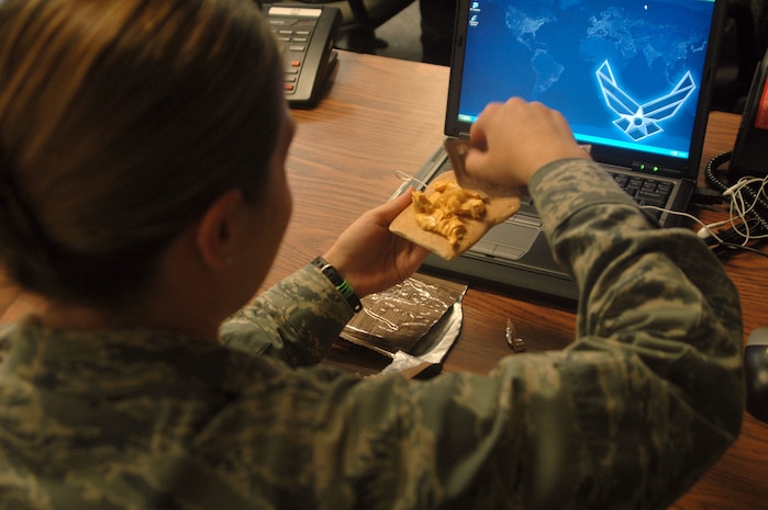 1st Lt. Tabitha Rand eats a Meal, Ready to Eat while at the emergency operation center Sept. 5. The 437th Force Support Squadron provided food, cots and blankets for EOC members during their 24-hour-a-day operations. Lieutenant Rand is the 437th Maintenance Squadron Fabrication Flight commander and was the 437th Maintenance Group EOC representative. (U.S. Air Force photo/Staff Sgt. Sam Hymas)